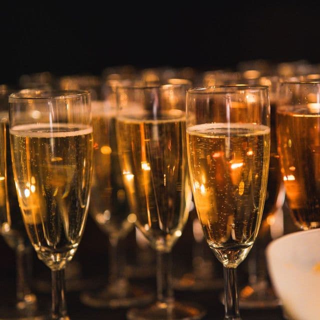Rows of golden champagne flutes ready for a toast